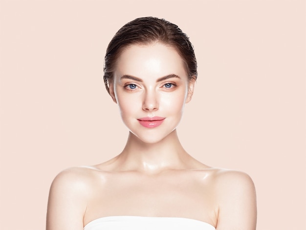 Woman cosmetic closeup beauty portrait healthy care skin and hair over beige color background