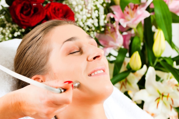 Woman in cosmetic salon receiving facial