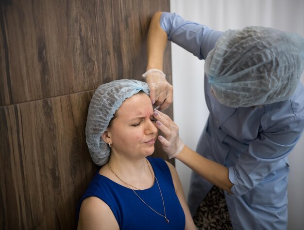 Woman in a cosmetology clinic the specialist doing injections