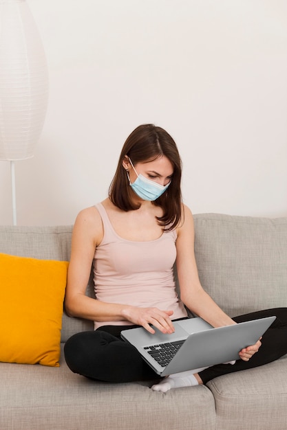 Woman on couch using laptop