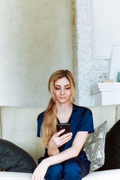 Woman on a couch using a phone