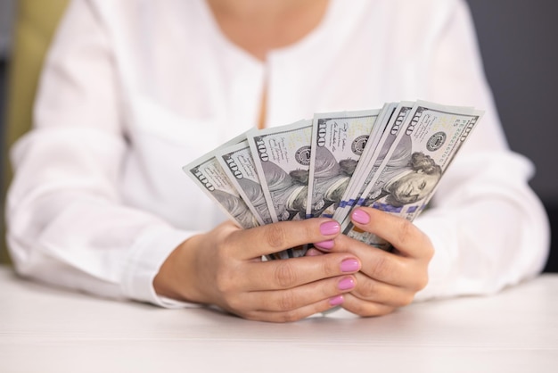 Woman counting dollar bills close up of female hands count money cash money calculation employee