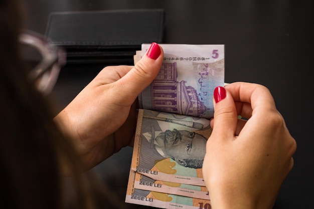 Woman counting money, counting LEI close up