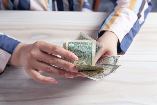 Woman counting money at the table