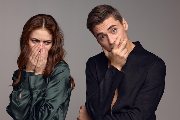 The woman covered her mouth with her hands and turned away from the surprised man High quality photo