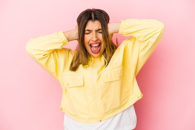 woman covering ears with hands trying not to hear too loud sound