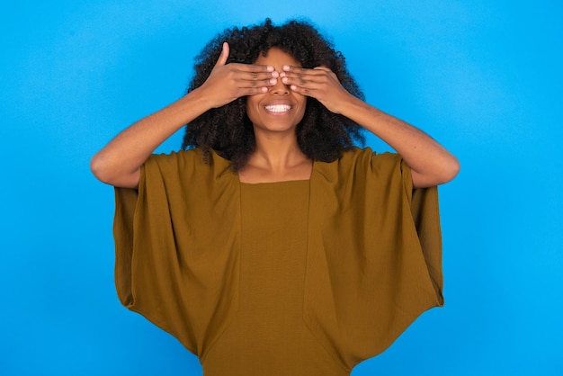 woman covering eyes with hands smiling cheerful and funny Blind concept