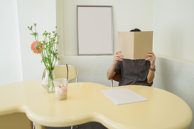 Photo woman covering her face with blank book or magazine in mock up concept