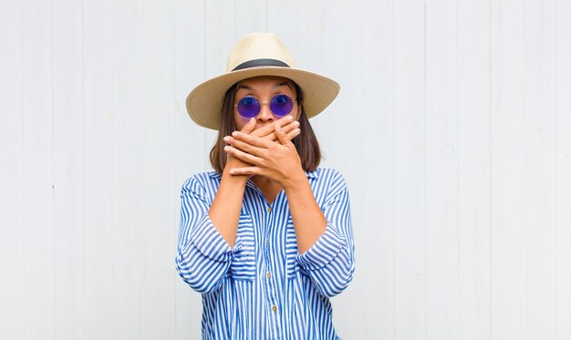 woman covering mouth with hands with a shocked