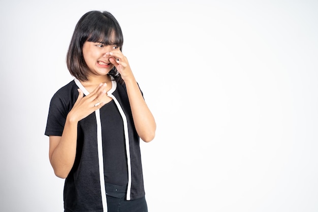 Woman covering nose with finger when bad smell