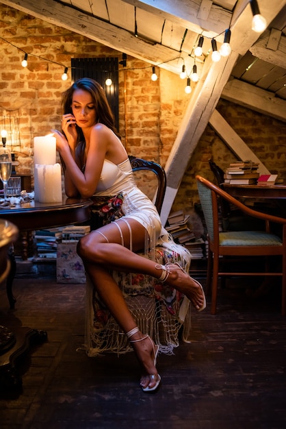 Woman in cozy evening interior with candles