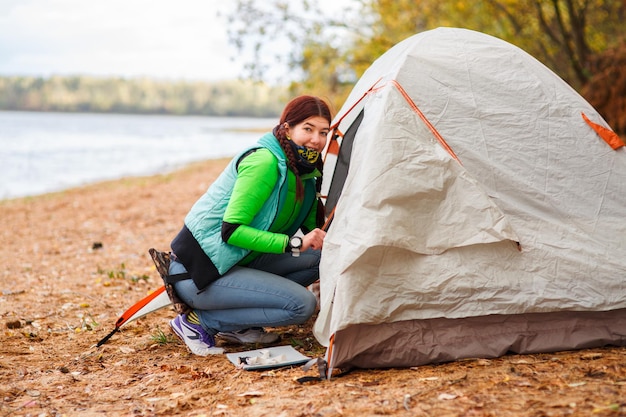 Woman crawls into tent