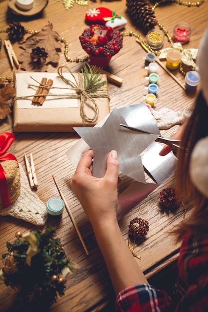 女性がクリスマスアクセサリーを作成します