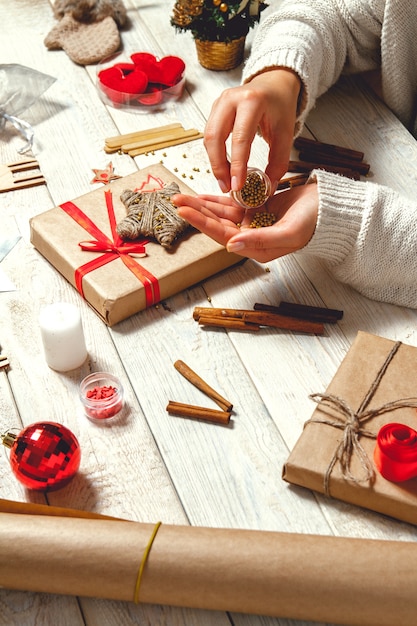 Woman creating stylish Christmas gifts