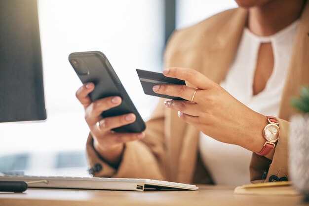 Woman credit card and hands with cellphone in office for finance business accounting and password Closeup of worker smartphone and internet payment for online shopping fintech and trading money