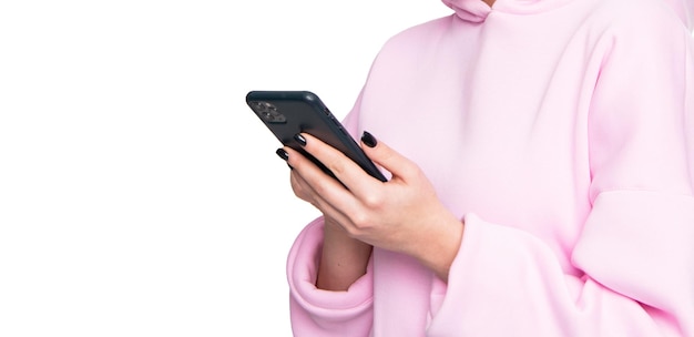 Woman crop view in casual pink hoodie using smartphone isolated on white social networking