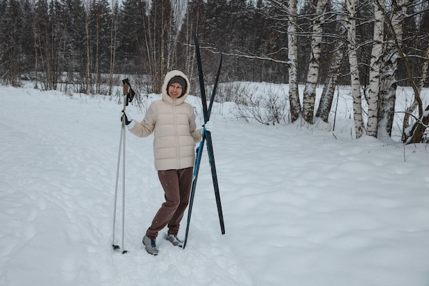 A woman on crosscountry skiing in a winter forest a healthy lifestyle concept a sporty lifestyle