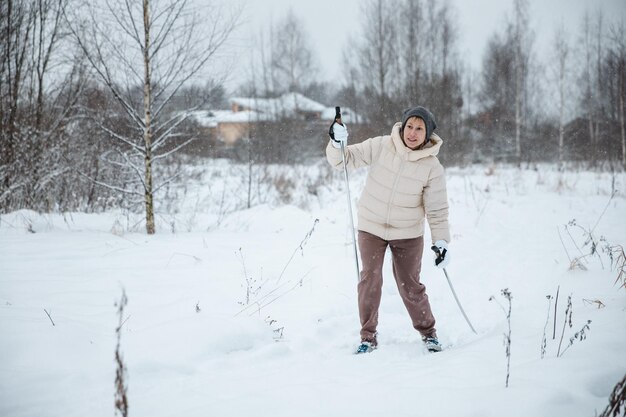 A woman on crosscountry skiing in a winter forest a healthy lifestyle concept a sporty lifestyle