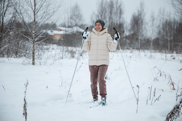 A woman on crosscountry skiing in a winter forest a healthy lifestyle concept a sporty lifestyle