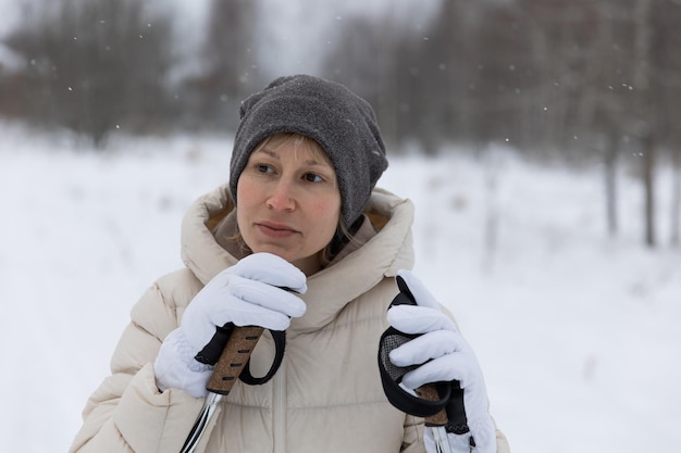 A woman on crosscountry skiing in a winter forest a healthy lifestyle concept a sporty lifestyle