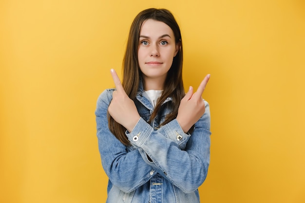 woman crosses hands over chest points sideways