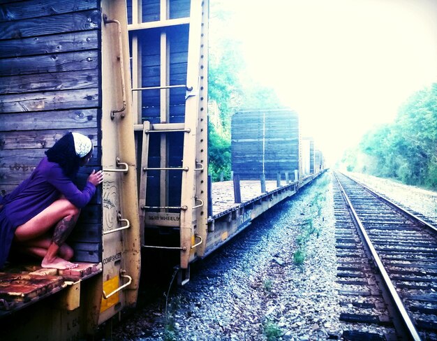 Foto donna accovacciata sul vagone ferroviario