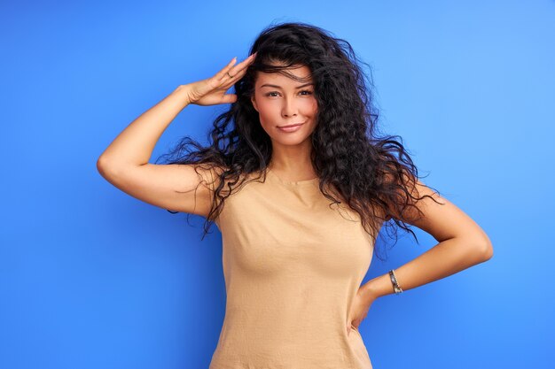 Woman , curly female in casual t-shirt showing positive emotions