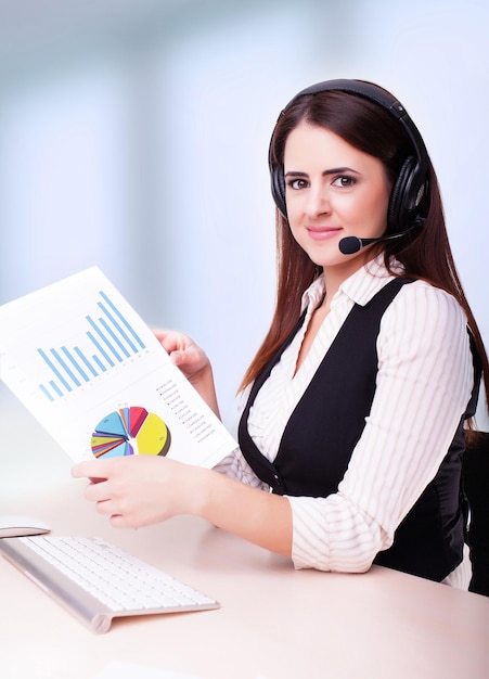 Woman customer service worker call center smiling operator with phone headset and holding document