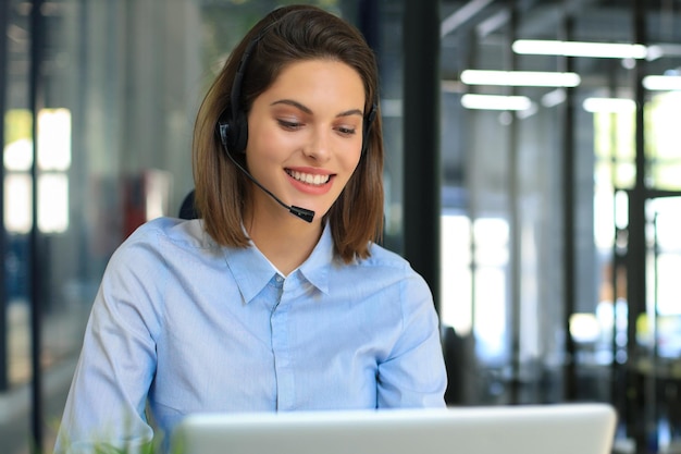 Woman customer support operator with headset and smiling