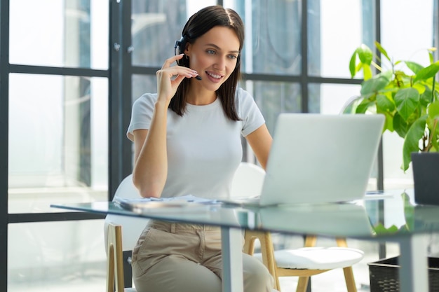 Woman customer support operator with headset and smiling