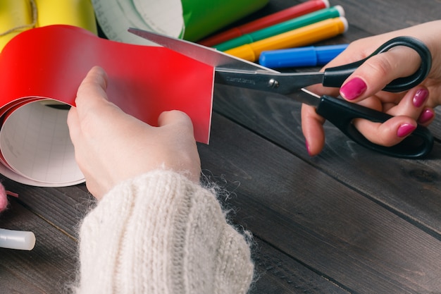 Woman cut red color paper