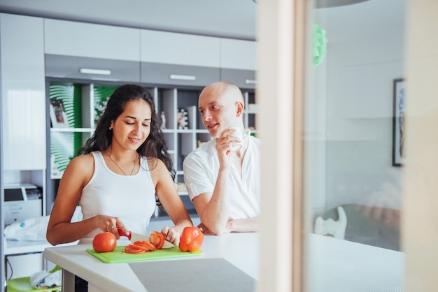 La donna ha tagliato insieme le verdure nella cucina.