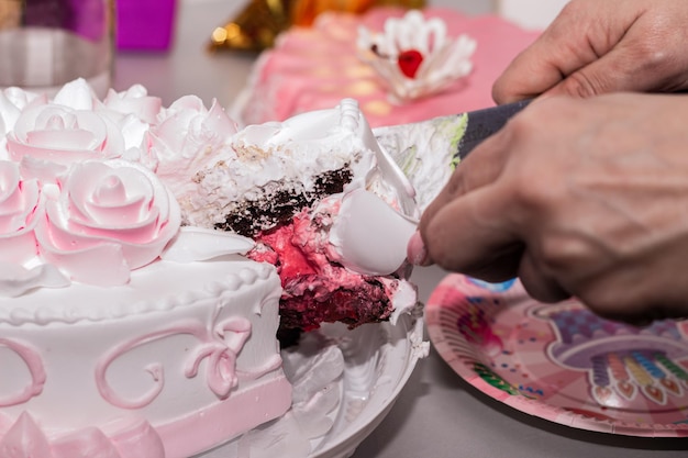 A woman cuts a cake with a knife