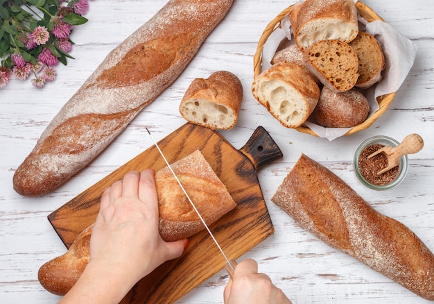 Woman cuts freshly baked bread