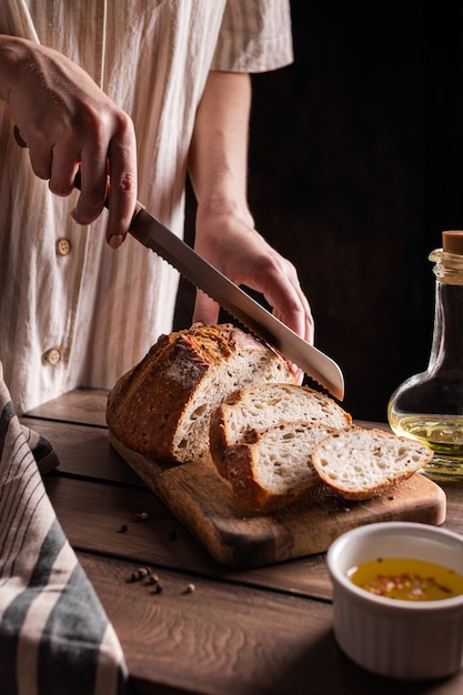 Woman cuts freshly baked bread