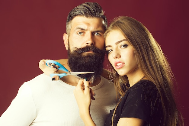 Woman cuttin male beard