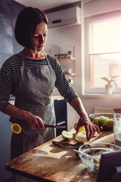 Woman cutting apples in the kitchen