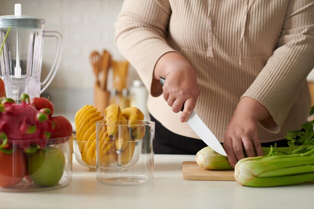 Woman Cutting Celery for Smothie