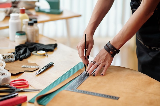 Woman Cutting Leather Piece in Stripes