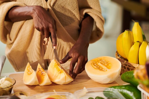 Woman Cutting Melon in Slices