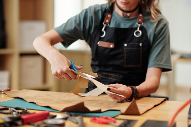 woman cutting out paper patterns