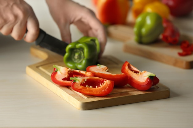 Woman cutting pepper in kitchen