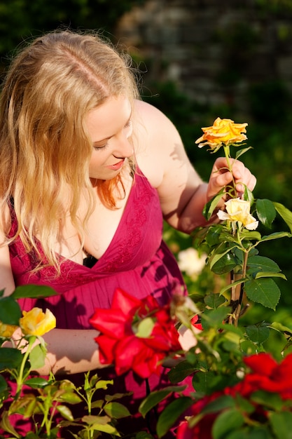 Woman cutting the roses in garden