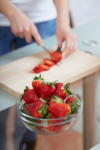 Woman cutting strawberries