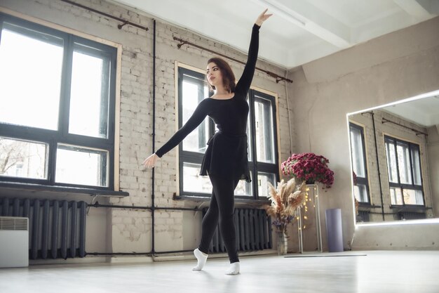 Woman dancer exercising in dance studio