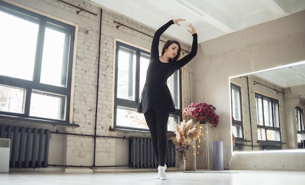 Woman dancer exercising in dance studio