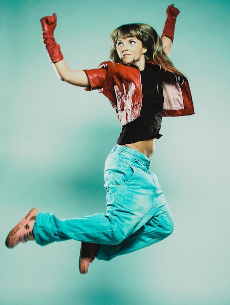 Woman dancer posing on studio background