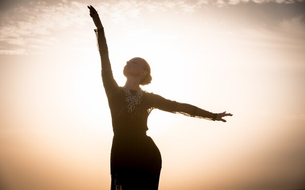 Woman dancing at sunrise