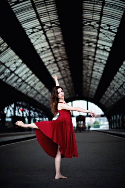 Woman dancing at a train station