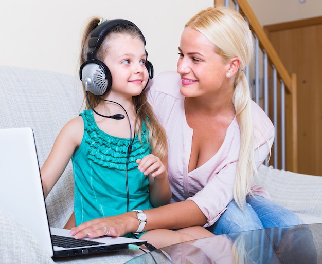 Woman and daughter chatting online